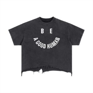 Black cropped T-shirt with a white curved slogan: BE A GOOD HUMAN, centered along the lower chest area and a distressed hem at bottom.