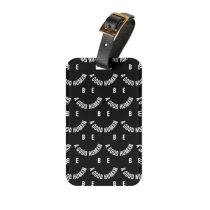 Black leather belt with a gold square buckle resting on a black display with white text motifs in the background.