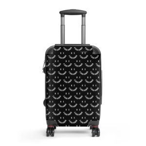 Black hard-shell rolling suitcase with a telescoping handle and four wheels, covered in a repeating 'BE' pattern with circular logos.