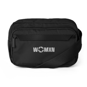 Close-up of a black backpack with a front zippered pocket and a circular 'WOMXN' logo on the front panel.